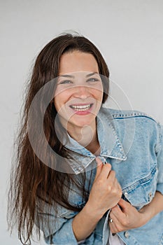 Portrait of happy young caucasian woman on white background, looking at camera, smiling.