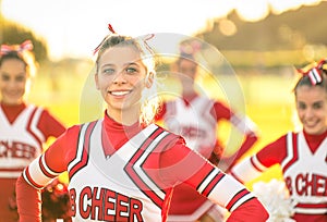 Portrait of an happy young cheerleader in action outdoors