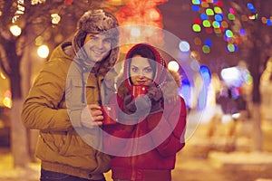 Portrait of a happy young couple on blurred lights background