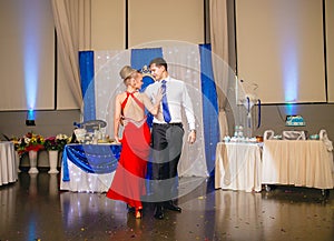 Portrait Of Happy Young Couple Dancing Tango at wedding banquet