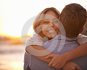 I could hug you forever. Portrait of a happy young couple enjoying a romantic embrace on the beach at sunset.