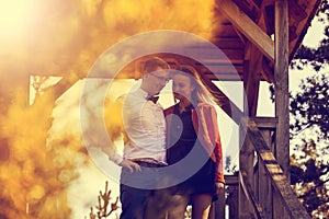 Portrait of happy young couple in love on blurred nature background in autumn. Vintage tone