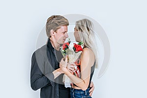 Portrait of happy young couple love together with flower in studio