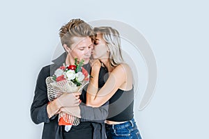 Portrait of happy young couple love together with flower in studio