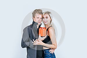 Portrait of happy young couple love together surprise with gift box in studio