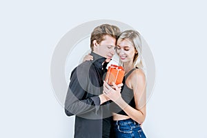 Portrait of happy young couple love together surprise with gift box in studio