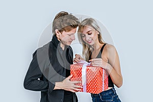 Portrait of happy young couple love together surprise with gift box in studio