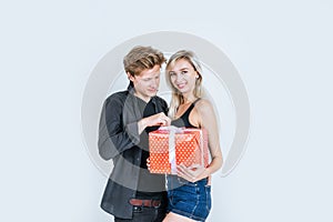 Portrait of happy young couple love together surprise with gift box in studio