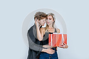 Portrait of happy young couple love together surprise with gift box in studio