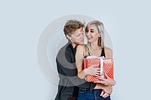 Portrait of happy young couple love together surprise with gift box in studio