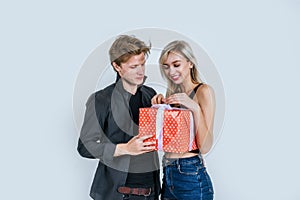 Portrait of happy young couple love together surprise with gift box in studio