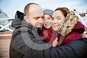 Portrait of happy young couple with son in park