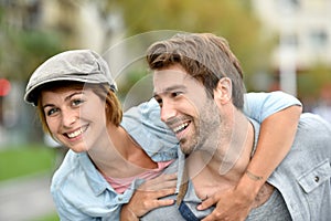 Portrait of happy young couple in the streets having fun