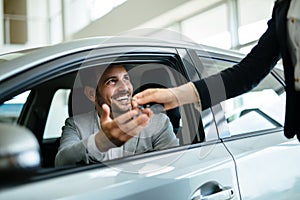 Portrait of happy customer buying new car photo