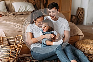Portrait of a happy young family. Happy family mother, father, little daughter.