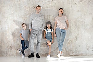 Portrait of happy young family with kids posing together