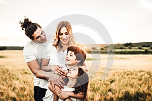 Portrait of a happy young family smiling in the countryside. Concept of family fun in nature