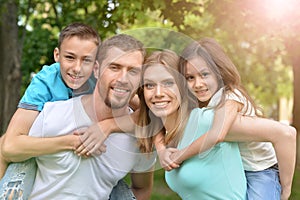 Portrait of happy young family in summer park