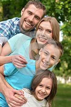 Portrait of happy young family in summer park