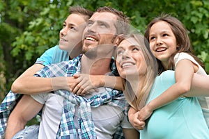 Portrait of happy young family in summer park