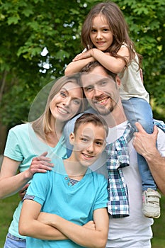 Portrait of happy young family in summer park