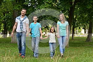 Portrait of happy young family in summer park