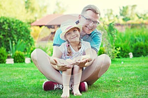 Portrait of happy young father with his pretty little daughter h