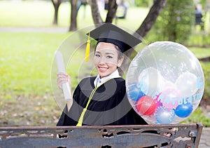 Portrait of happy young female graduates in academic dress