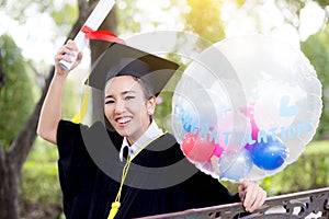 Portrait of happy young female graduates in academic dress