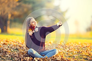 Portrait of happy young girl with headphones and smartphone in a