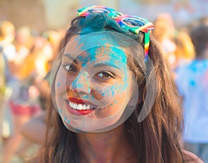 Portrait of happy young girl on holi festival