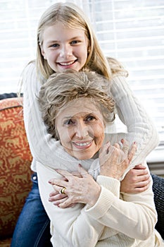 Portrait of happy young girl hugging grandmother