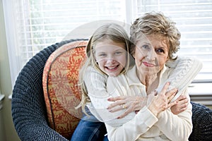Portrait of happy young girl hugging grandmother