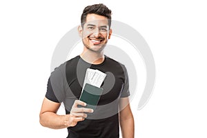 Portrait Of Happy Young Guy Holding Passport And Boarding Pass