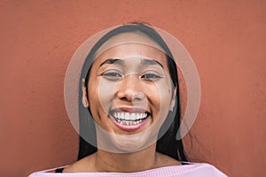 Portrait of happy young hispanic woman smiling in front camera