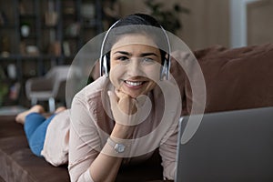 Portrait of happy young Indian woman in headphones.