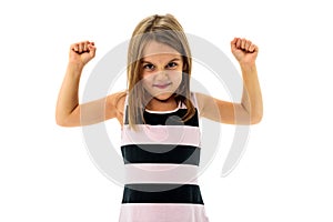 Portrait of happy young little girl showing and flexing muscles.