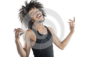 Portrait of a happy young man gesturing while listening to mp3 player over white background