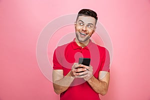 Portrait of a happy young man holding mobile phone