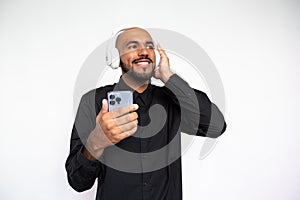 Portrait of happy young man listening to mp3 player on phone