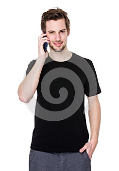 Portrait of happy young man talking on cell phone isolated on white background