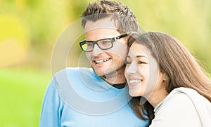 Portrait of happy young man and woman in park.