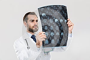 Portrait of happy young medical doctor working in hospital and holding X-ray scan