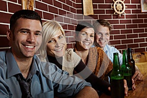 Portrait of happy young people in pub
