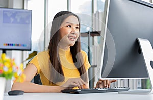Portrait happy young programmer Asian woman work at start up technology office and using computer for coding application program