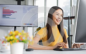 Portrait happy young programmer Asian woman work at start up technology office and using computer for coding application program