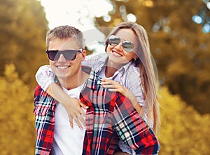 Portrait happy young smiling couple having fun together outdoors in warm autumn day