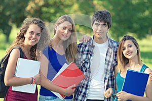 Portrait happy young students in park