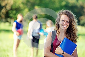 Portrait happy young students in park