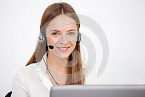 Portrait of happy young support phone operator with headset.